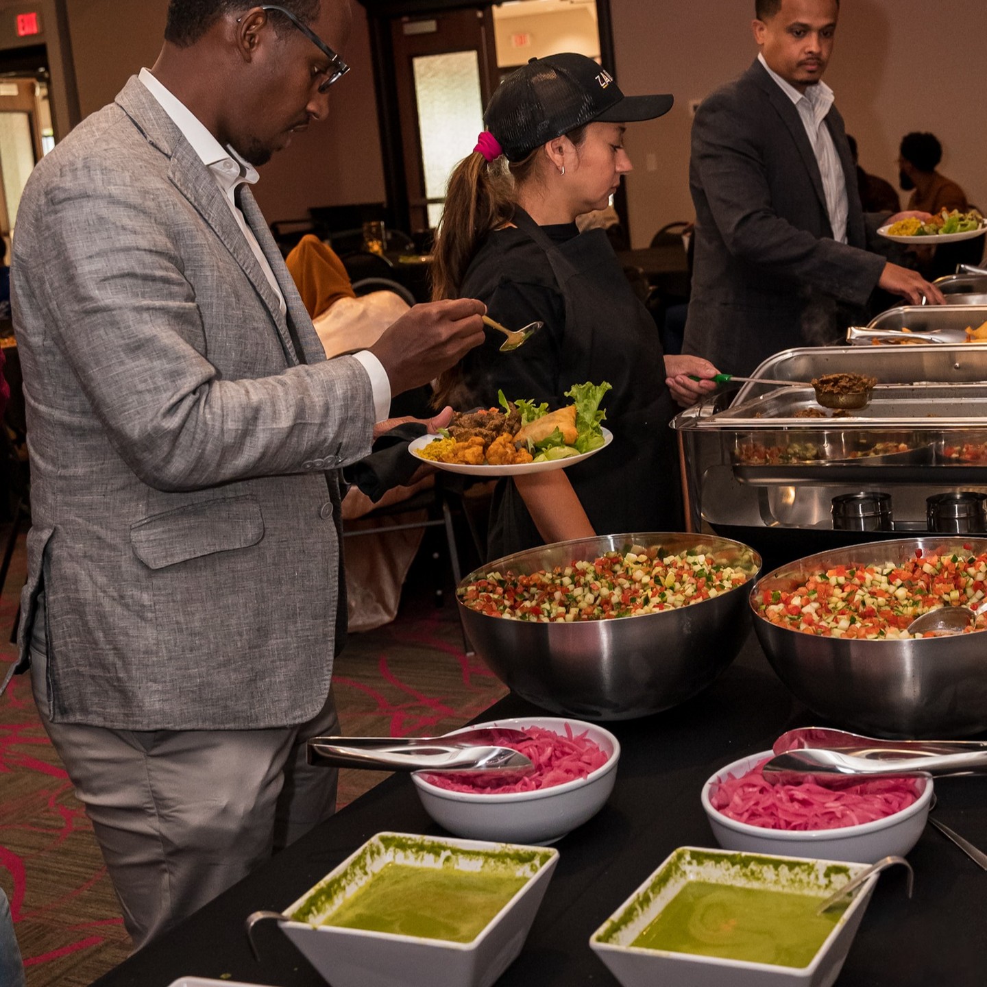 Guests enjoying a warm catered meal at Zawadi Center