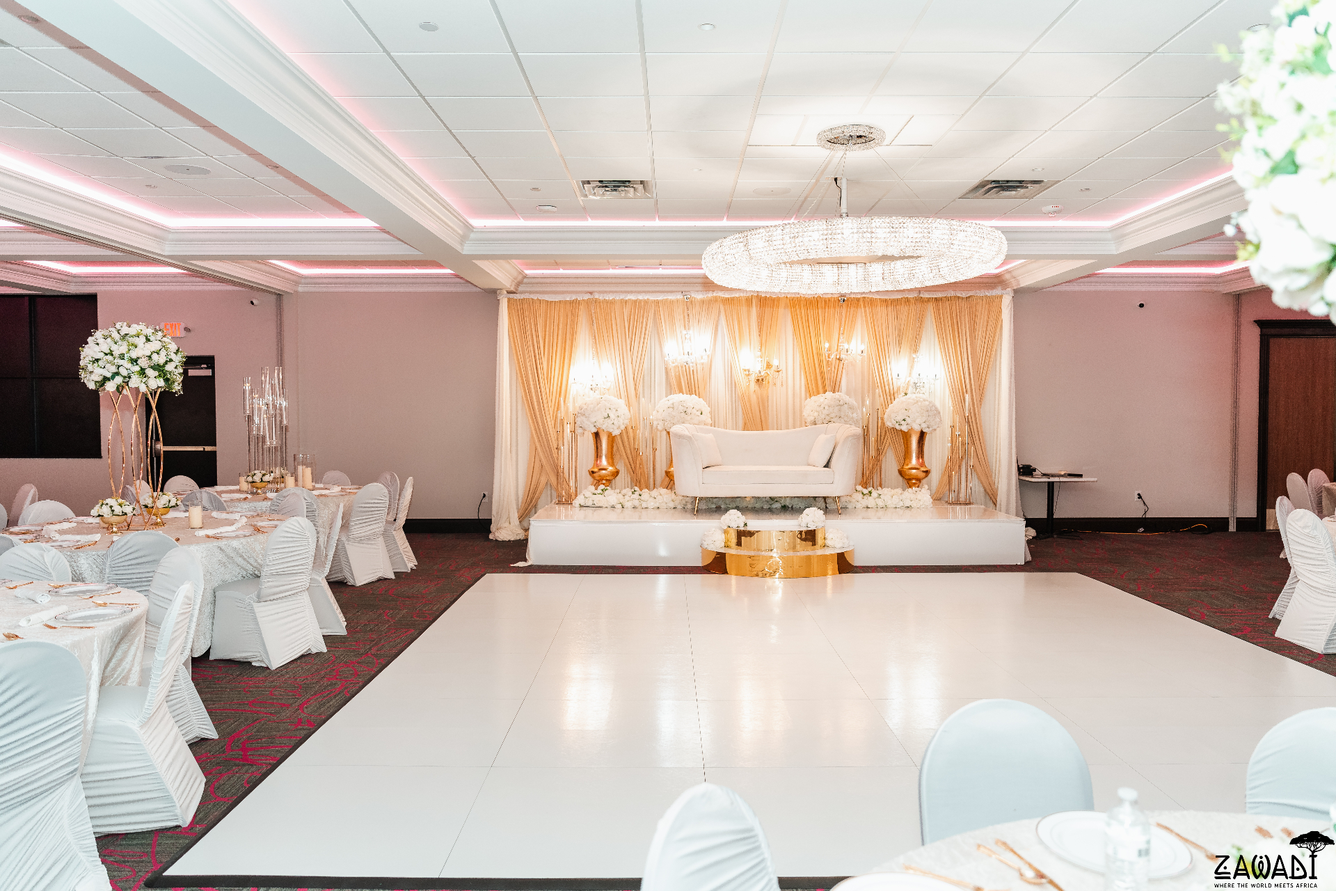 Floral ceremony arch with soft warm lighting